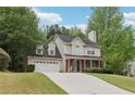 Charming two-story home featuring a well-manicured front yard and a brick-accented facade at 179 Parkside Dr, Stockbridge, GA 30281