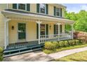 Inviting front porch with charming details, seating, and lush landscaping at 3627 Pebble Hill Ne Dr, Marietta, GA 30062