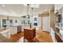 Gourmet kitchen featuring an island, stainless steel appliances, and hardwood floors, blending functionality and style at 470 W Magnolia Cir, Johns Creek, GA 30005