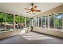 Cozy sunroom filled with natural light, perfect for relaxation and enjoying views of the landscaped backyard at 470 W Magnolia Cir, Johns Creek, GA 30005