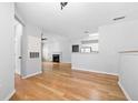 Open-concept living room with hardwood floors, a fireplace, and seamless flow into the adjacent kitchen at 603 Spring Heights Se Ln # 6, Smyrna, GA 30080