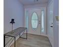 Inviting entryway features light grey walls and luxury vinyl plank flooring at 1080 Smoke Hill Ln, Hoschton, GA 30548
