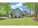 Well-maintained home with lush green lawn and mature trees in a quiet neighborhood at 1080 Smoke Hill Ln, Hoschton, GA 30548