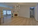 Open living room showcasing modern light fixture, fireplace, and seamless flooring at 1080 Smoke Hill Ln, Hoschton, GA 30548