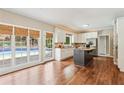 Well-lit kitchen features stainless appliances, granite countertops, and a large central island at 5605 Preserve Cir, Johns Creek, GA 30005