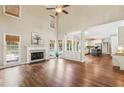 Bright and airy living room boasts hardwood floors, fireplace, and views of the backyard pool at 5605 Preserve Cir, Johns Creek, GA 30005