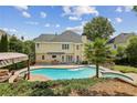 Gorgeous in-ground pool with attached spa and patio area, perfect for outdoor relaxation and entertainment at 5605 Preserve Cir, Johns Creek, GA 30005