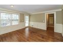 Bright living room featuring hardwood floors, wainscoting, and a door to the outdoor deck at 1960 Mceachern Manor Sw Dr, Marietta, GA 30064