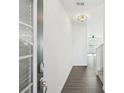 Bright entryway with hardwood floors, and a modern light fixture, leading into the home's living spaces at 2946 Stockholm Way, Suwanee, GA 30024