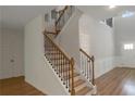Elegant foyer with a staircase featuring wood and wrought iron, plus detailed wainscoting at 420 Tavistock Ct, Mcdonough, GA 30252