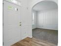 Bright foyer featuring hardwood floors, an arched doorway, and white trim at 3656 Oak Sw Ln, Powder Springs, GA 30127