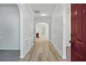 Bright foyer featuring archways, hardwood flooring and white wainscoting; offering a welcoming entrance at 3656 Oak Sw Ln, Powder Springs, GA 30127