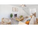 Bright living room with fireplace, ceiling fan, and cozy seating arrangement at 1560 Temple Ave, College Park, GA 30337