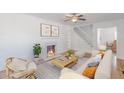 Cozy living room with fireplace, neutral color palette, and a comfortable rattan chair at 1560 Temple Ave, College Park, GA 30337