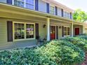 Inviting front porch with red doors and black shutters, complemented by lush green landscaping at 351 Ridgewater Dr, Marietta, GA 30068