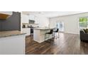 Bright kitchen with white cabinets, granite countertops, stainless steel appliances, and luxury vinyl plank flooring at 1196 Erica Se Way, Atlanta, GA 30354