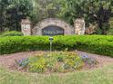 Stone Haley's Mill entrance sign adorned with colorful flowers and trimmed hedges at 135 Haleys Cir, Woodstock, GA 30188