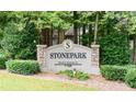 Stonepark private residence sign with decorative stone pillars, manicured greenery and trees as a backdrop at 2007 Wingate Way, Atlanta, GA 30350