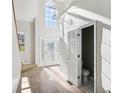 Inviting entryway boasts soaring ceilings, light wood floors, and decorative glass front door at 3045 Wyntree Dr, Peachtree Corners, GA 30071
