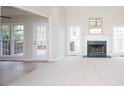 Bright living room with large windows, fireplace, and an open doorway to the outdoor deck at 3045 Wyntree Dr, Peachtree Corners, GA 30071