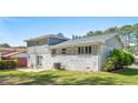 The back of the home is brick with a small patio and well manicured lawn at 4269 Indian Forest Trl, Stone Mountain, GA 30083
