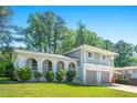 Charming two-story home featuring a beautiful brick facade, arched porch, second story balcony and well-maintained lawn at 4269 Indian Forest Trl, Stone Mountain, GA 30083