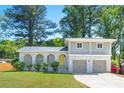 Charming two-story home featuring a beautiful brick facade, arched porch, second story balcony and well-maintained lawn at 4269 Indian Forest Trl, Stone Mountain, GA 30083