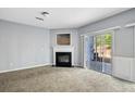 Living room with fireplace, carpet floors, and sliding glass doors leading to an outdoor area at 2872 Cross Creek Ct, Cumming, GA 30040