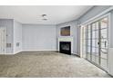 Bright living room with fireplace, carpet floors, and sliding glass doors with a view at 2872 Cross Creek Ct, Cumming, GA 30040