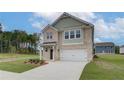 Charming two-story home with brick facade, a well-manicured lawn, and an attached two-car garage at 40 Begonia Ct, Covington, GA 30016