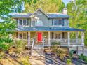 Inviting two-story home with a covered front porch and a lovely green lawn at 6 Sentry Rdg, Dallas, GA 30157