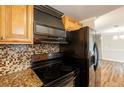 Stylish kitchen with granite countertops, matching appliances, and mosaic tile accents at 110 Valley View Ct, Tyrone, GA 30290