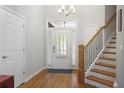 Bright foyer featuring hardwood floors, staircase, and natural light at 123 Heritage Pointe, Woodstock, GA 30189