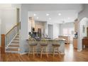 Open kitchen with granite countertops and a breakfast bar at 123 Heritage Pointe, Woodstock, GA 30189