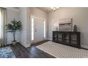 Inviting entryway featuring hardwood floors, a stylish cabinet, and decorative wall art at 259 Eason Ave, Bowdon, GA 30108