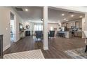 Open-concept space with a fireplace, kitchen island with bar seating, and hardwood floors at 259 Eason Ave, Bowdon, GA 30108