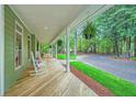 Covered front porch with rocking chairs and hanging plants, offering a relaxing outdoor space at 2010 Univeter Rd, Canton, GA 30115