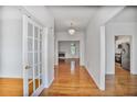 Bright foyer with hardwood floors and views into the living room and kitchen at 2620 Nesbitt Crossing Way, Duluth, GA 30096