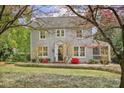 Inviting two-story home framed by flowering trees and lush landscaping, creating a picturesque and welcoming curb appeal at 452 Cherokee Ne St, Marietta, GA 30060