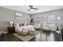 Spacious bedroom with neutral tones, a plush bed, and comfortable seating area at 6442 Canopy Dr, Sandy Springs, GA 30328