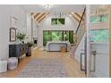 Bright living room with wooden floors, vaulted ceilings, and sliding glass doors to backyard at 0 Chattahoochee St, Roswell, GA 30075