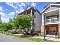 Modern townhome featuring double balconies, street view with manicured landscaping at 1434 Fairmont Ave, Atlanta, GA 30318