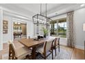 Bright dining room featuring a modern light fixture and an open view to the neighborhood at 313 Brooke View Trl, Canton, GA 30115