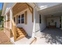 Close up of the home's covered port and wooden porch with newly stained lumber at 1045 Ridgecrest Se Dr, Smyrna, GA 30080
