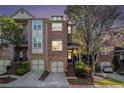Charming brick townhome with a two-car garage and lovely landscaping at 1976 Cobblestone Ne Cir, Atlanta, GA 30319