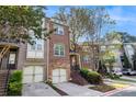 Attractive brick townhome with a two-car garage, and front yard landscaping at 1976 Cobblestone Ne Cir, Atlanta, GA 30319