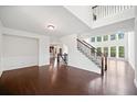 Bright and airy living room featuring hardwood floors, a staircase, and large windows letting in natural light at 4180 Woodwind Dr, Cumming, GA 30028