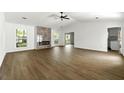 Open-concept living room with a fireplace and views of the backyard at 2254 Lisbon Ln, Jonesboro, GA 30236