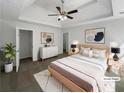 Serene main bedroom with a tray ceiling, ceiling fan, and neutral color scheme at 4269 David Austin Ct, Snellville, GA 30039