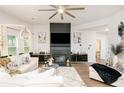 An open-concept living room featuring modern fireplace, sleek furniture, and plenty of natural light at 475 Mcdonough Rd, Fayetteville, GA 30214